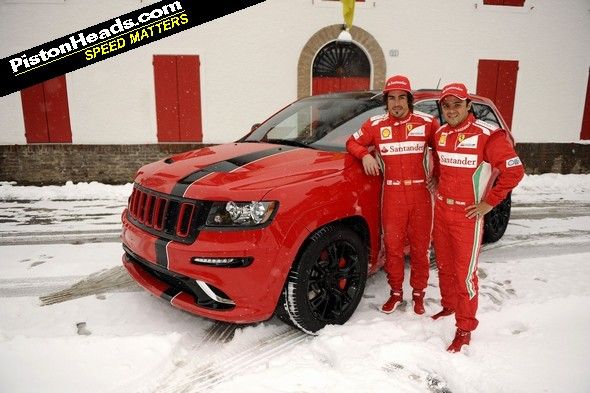 Alonso and Massa stand in front of their new 'ride'. Presumably to hide its hideousness